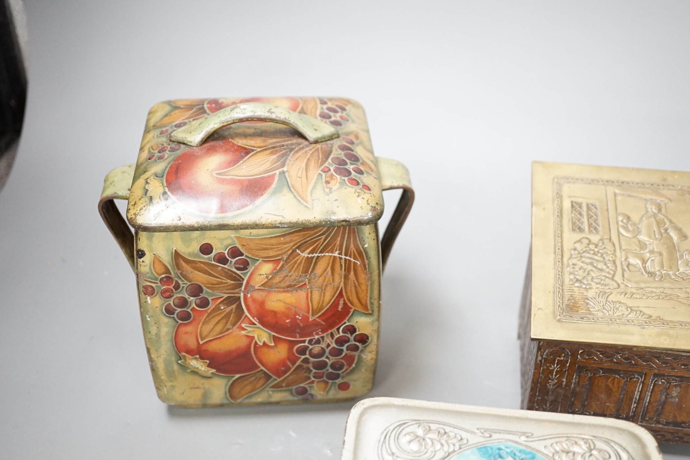A Jacobs embossed coffer shaped biscuit tin, 16cm wide, a Pomegranate design tin after Moorcroft and one other biscuit tin, (3)